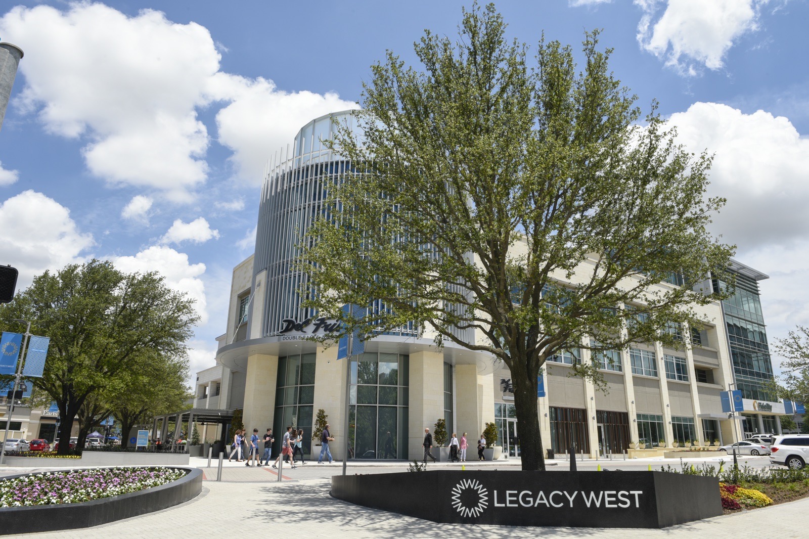 The Legacy West development in Plano, Texas, with pedestrians on the plaza